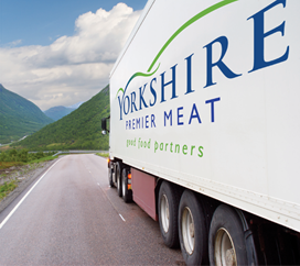 Yorkshire Premier Meat delivery lorry on country road.